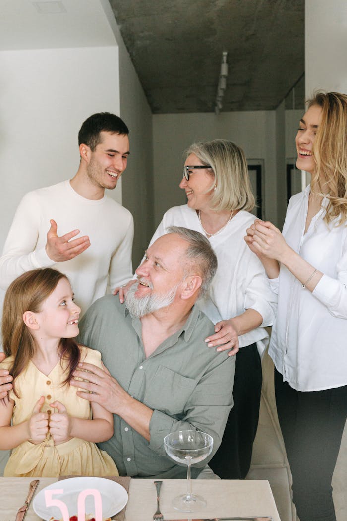services-02 A joyful family gathering indoors celebrating a significant milestone with smiles and conversation.