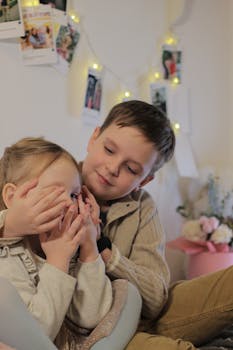 A young boy and girl playing happily together, showcasing sibling love and joy.